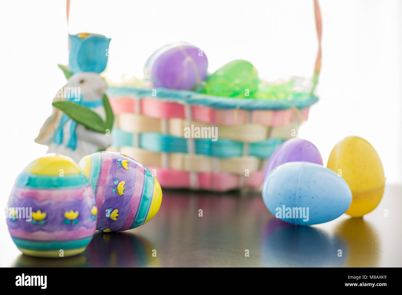 An Easter Bunny is set a long side his basket filled with Easter Eggs ...
