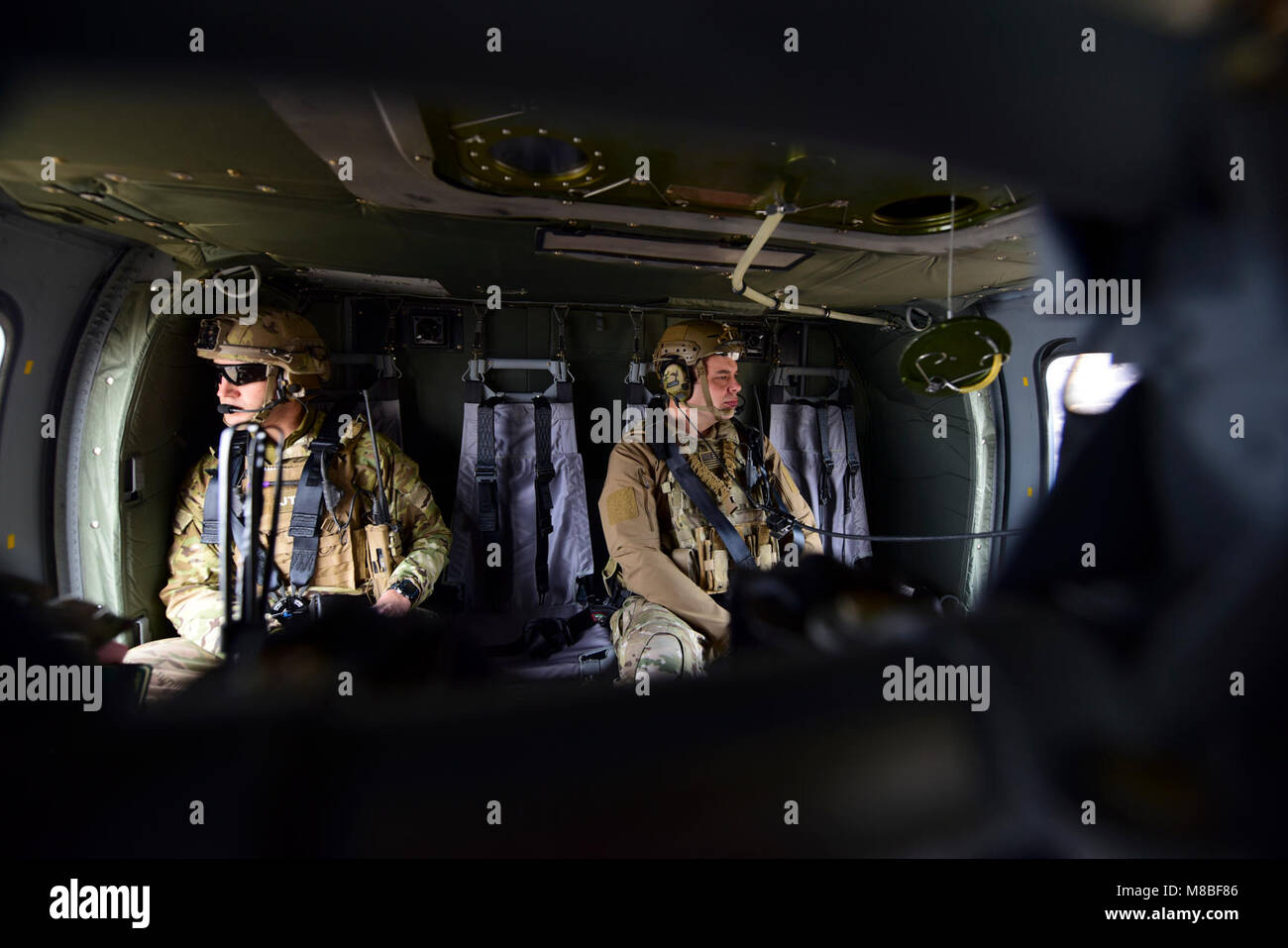 Joint Terminal Attack Controllers ride in a UH-0 Black Hawk during a joint training at Warsaw, Mo., Jan. 31, 2018. The training, titled Truman Relief, gave Whiteman Air Force Base, Mo., units the opportunity to go through scenarios involving JTACs capabilities. (U.S. Air Force by Staff Sgt. Danielle Quilla) Stock Photo