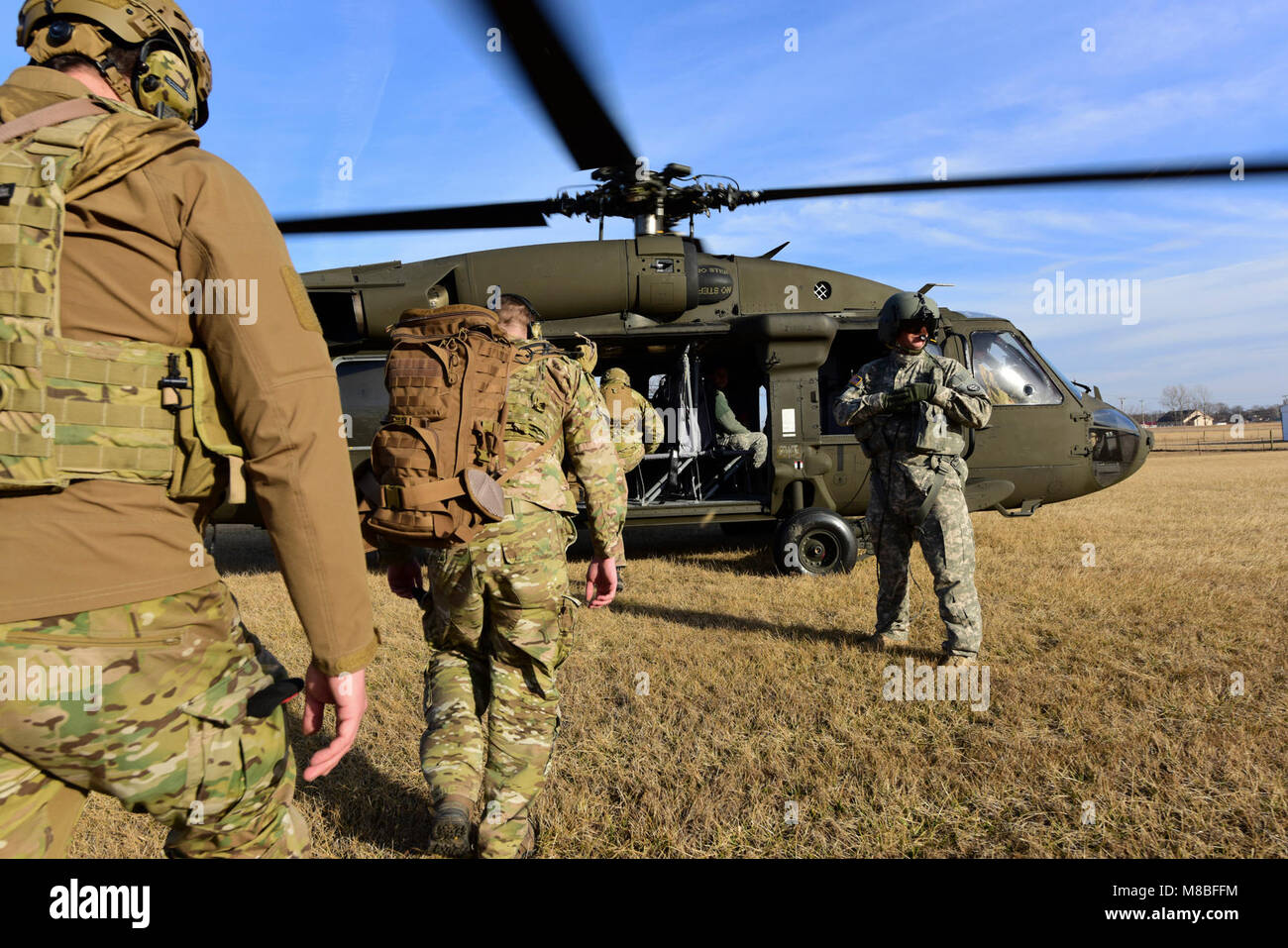 Joint Terminal Attack Controllers assigned to the 7th Air Support Operations Squadron from Fort Bliss, Texas, enter a UH-0 Black Hawk during a joint training mission at Warsaw, Mo., Jan. 31, 2018. The joint training, titled Truman Relief, involved the 509th Bomb Wing and 1-135th Assault Helicopter Battalion from Whiteman Air Force Base, Mo. (U.S. Air Force by Staff Sgt. Danielle Quilla) Stock Photo