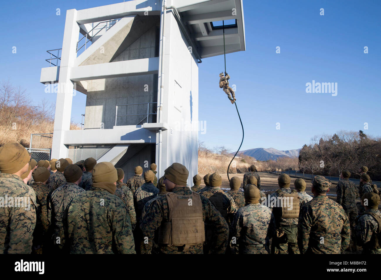 U.S. Marine Corps Sgt. Dallas Bush demonstrates fast rope techniques to ...