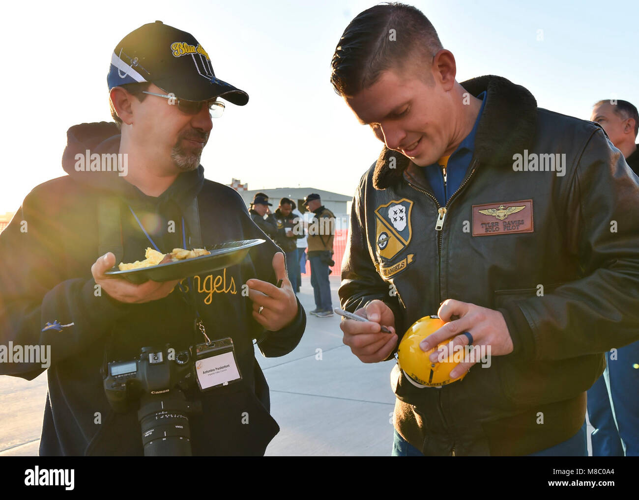EL CENTRO, Calif. (Feb. 24, 2018) Blue Angels Lead Solo Pilot, Lt. Tyler Davies, signs a fan's miniature helmet during a breakfast event at NAF El Centro. The Blue Angels are scheduled to perform more than 60 demonstrations at more than 30 locations across the U.S. in 2018. (U.S. Navy Stock Photo
