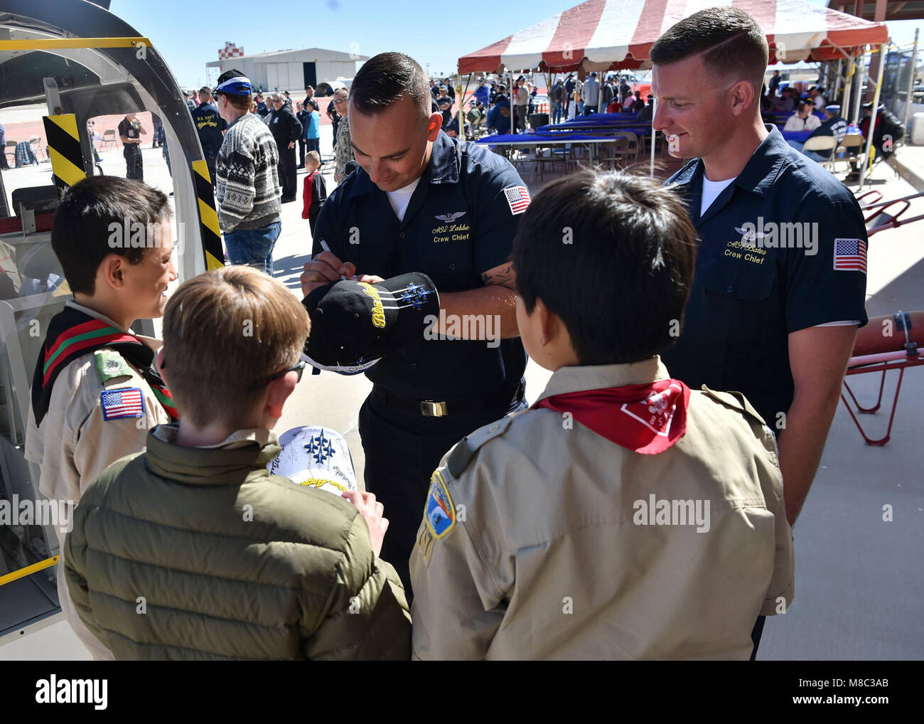 EL CENTRO, Calif. (Feb. 24, 2018) Blue Angels Crew Chiefs, Aviation Ordnanceman 2nd Class, Josh Labbe, and Aviaton Ordnanceman 1st Class, Brandon Bates, sign autographs for local Boy Scouts following a practice demonstration. The Blue Angels are scheduled to perform more than 60 demonstrations at more than 30 locations across the U.S. in 2018. (U.S. Navy Stock Photo