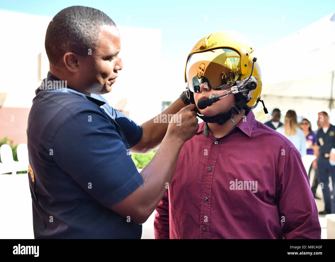 CENTRO, Calif. (Feb. 25, 2018) Aviation Ordnanceman, Roderick Stevenson, shows a young fan a pilot's helmet at El Centro Regional Medical Hospital during a meet and greet event. The Blue Angels are scheduled to perform more than 60 demonstrations at more than 30 locations across the U.S. in 2018. (U.S. Navy Stock Photo