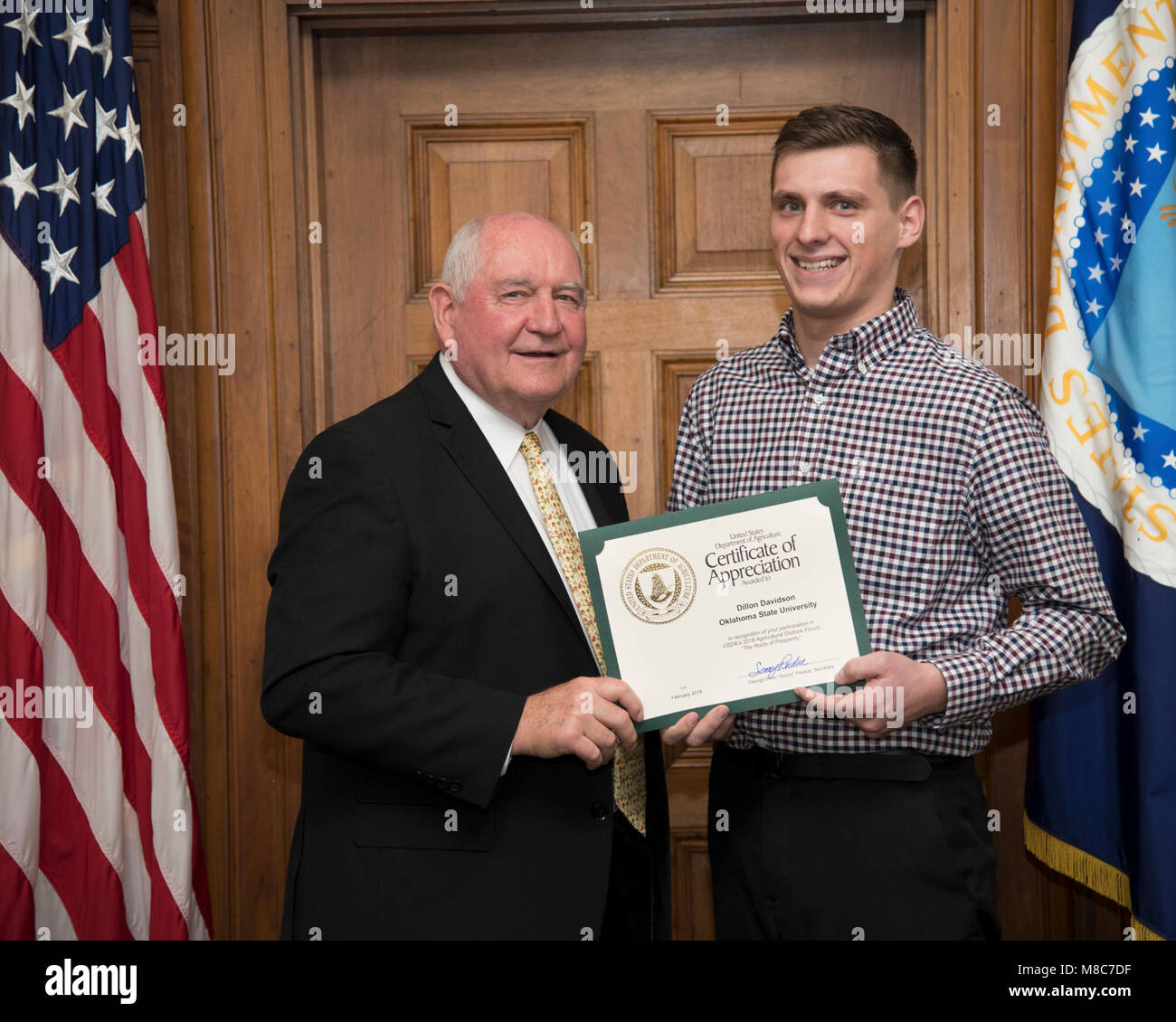 U.S. Department of Agriculture ) Secretary Sonny Perdue presents a certificate of appreciation