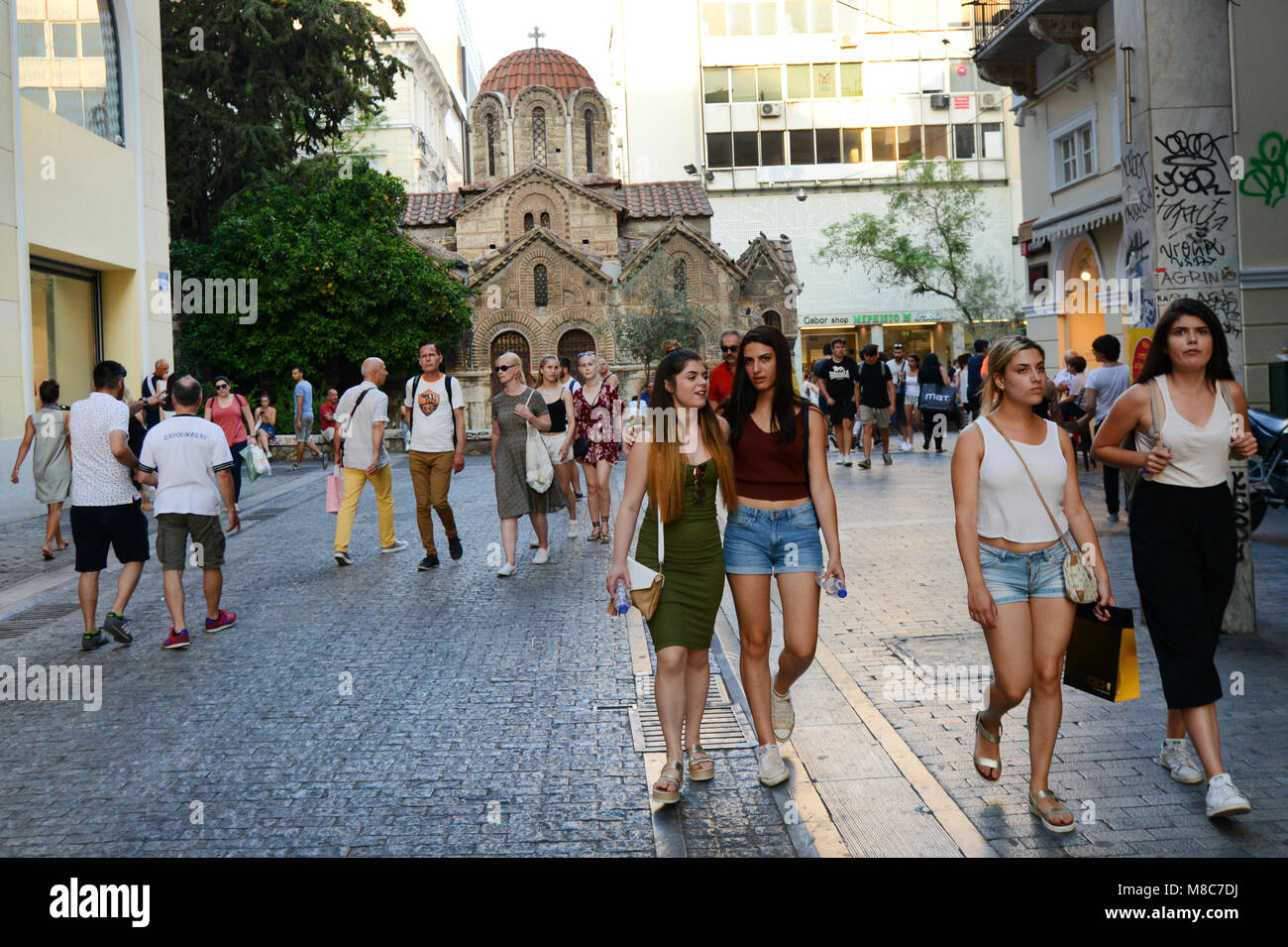 Ermou pedestrian street is always busy with shoppers and tourist. Stock Photo