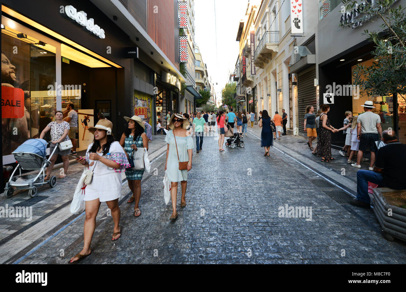 Ermou pedestrian street is always busy with shoppers and tourist. Stock Photo