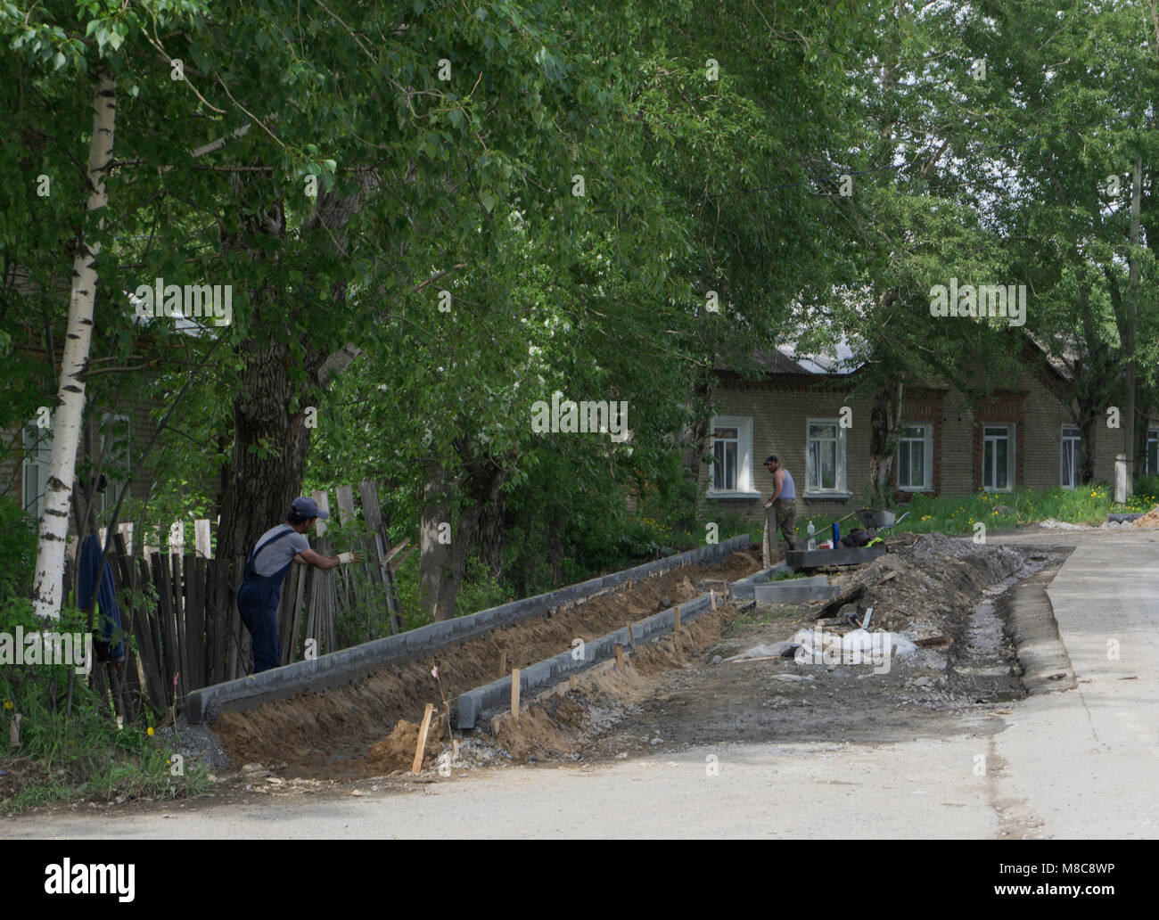 Concrete curb installation. String line level guide is stretched