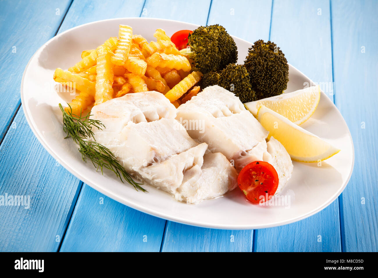 Fish dish - fried fish fillet and vegetables Stock Photo - Alamy