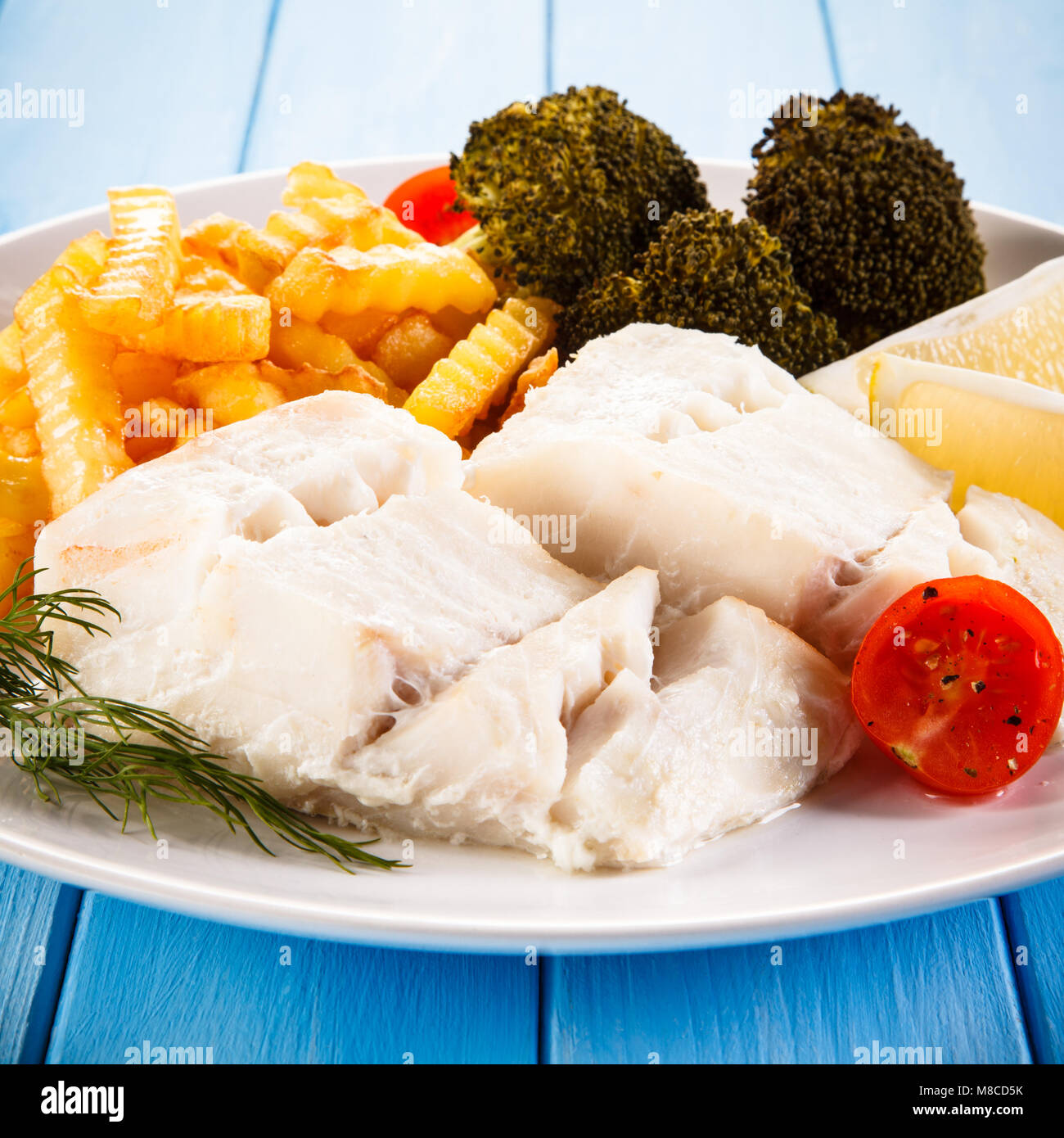 Fish dish - fried fish fillet and vegetables Stock Photo - Alamy