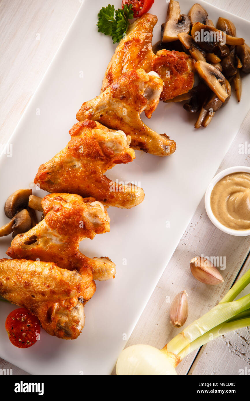 Grilled chicken wings on wooden table Stock Photo