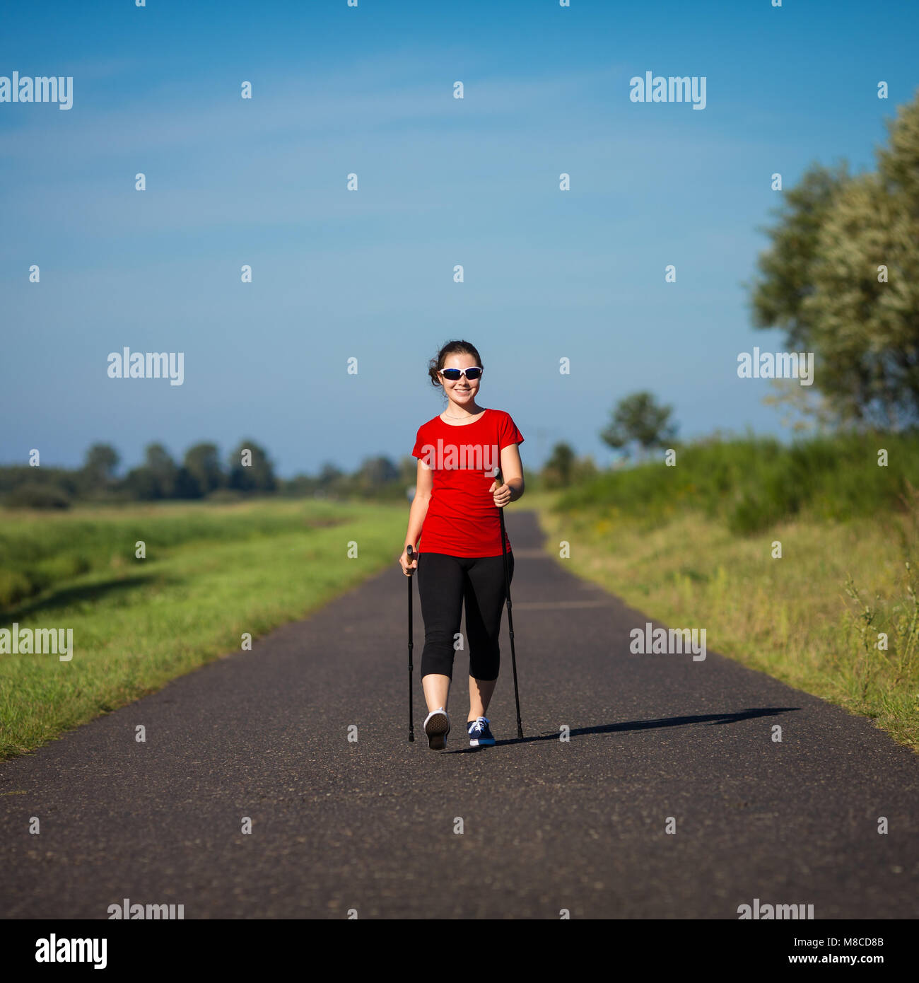 Nordic walking - young woman training Stock Photo