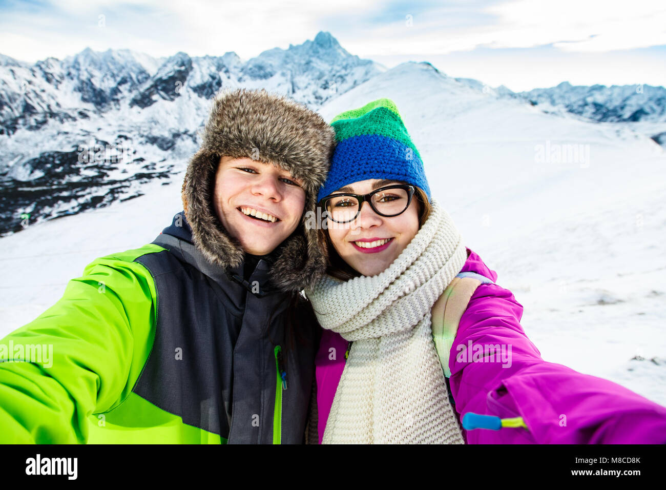 Winter vacation - teens in mountain Stock Photo