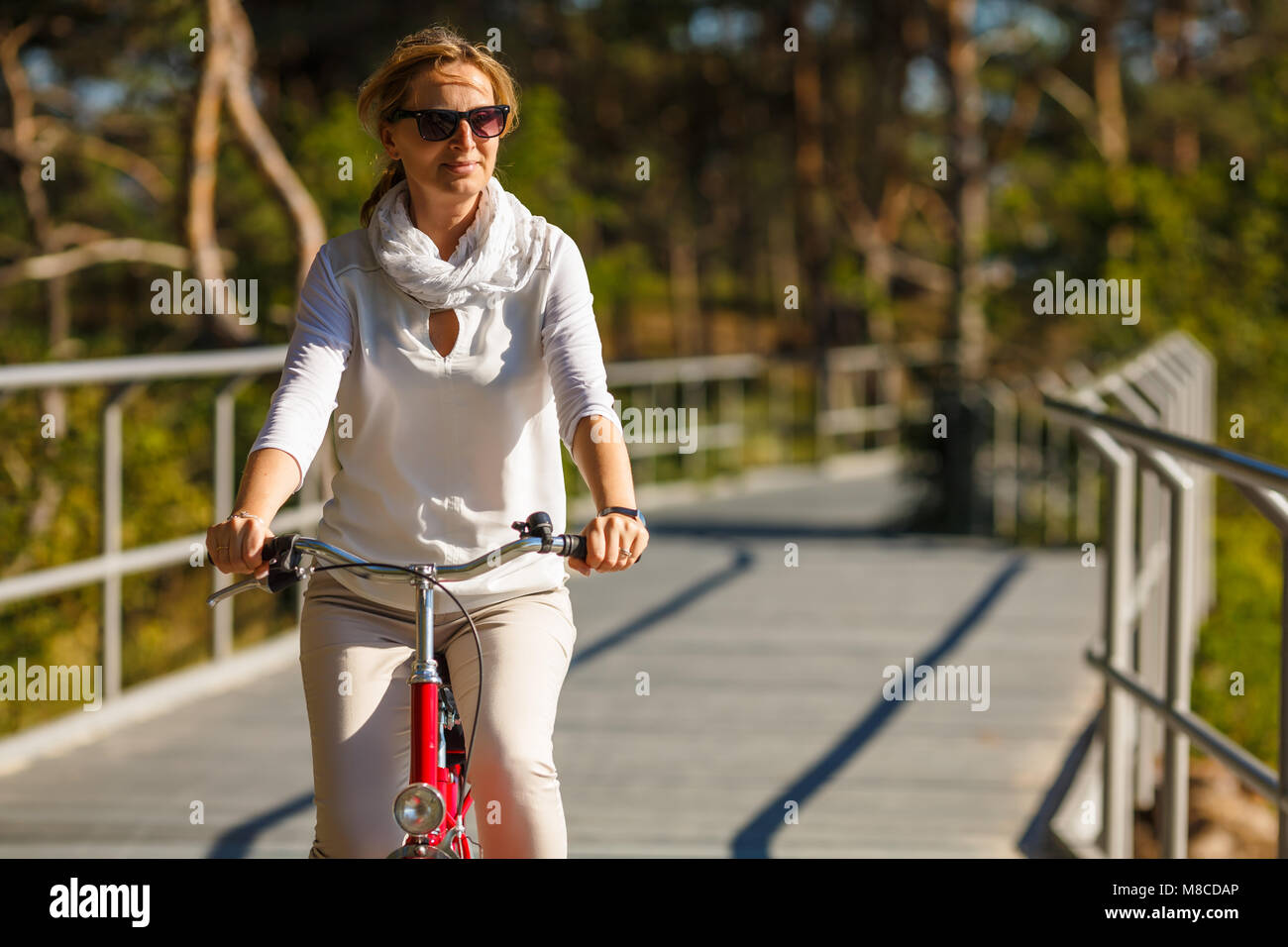 Woman riding bike outdoor Stock Photo - Alamy