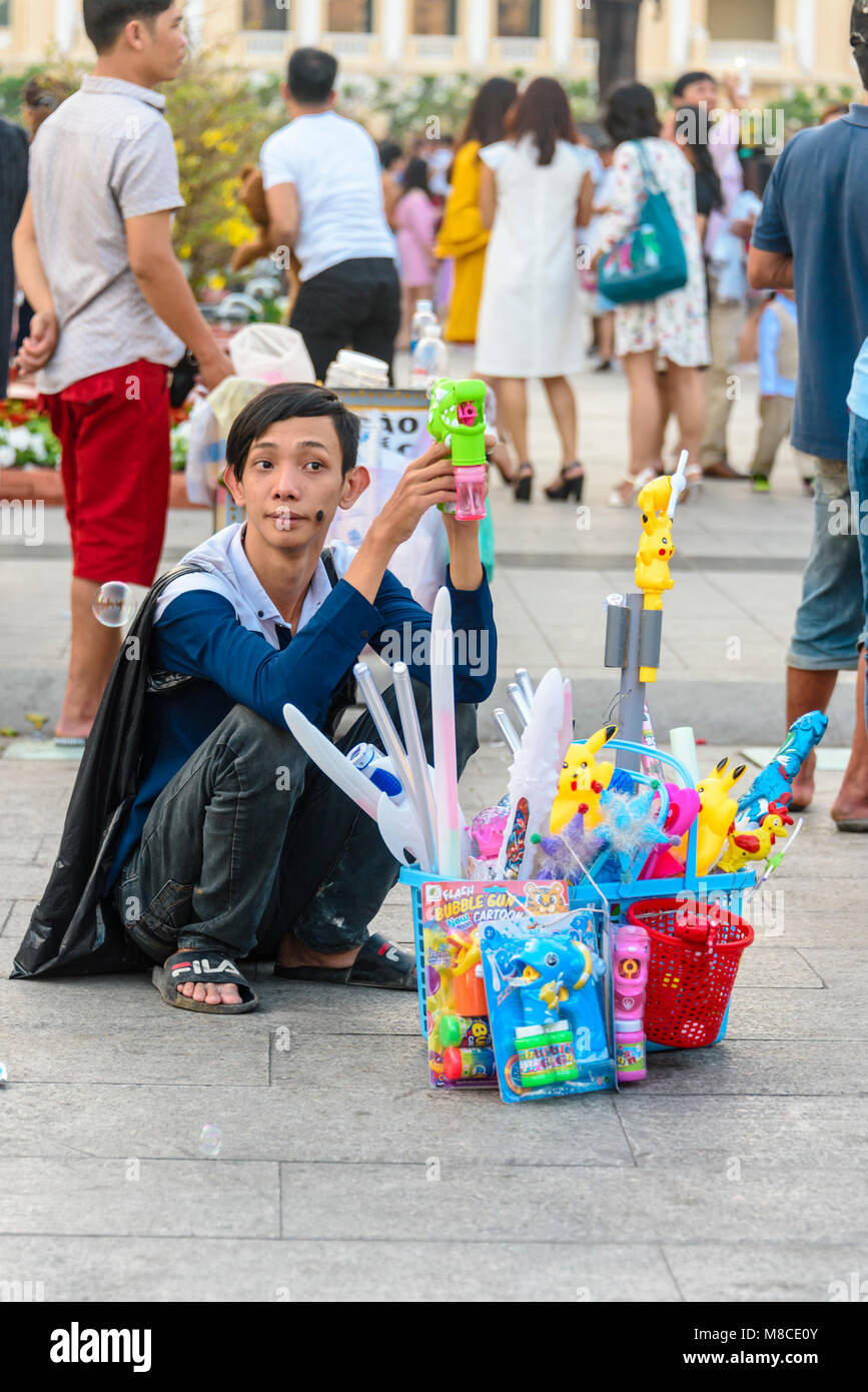 A street vendor selling cheap toys including illuminated swords, Pokemon and bubble machines, Ho Chi Minh City, Saigon, Vietnam Stock Photo