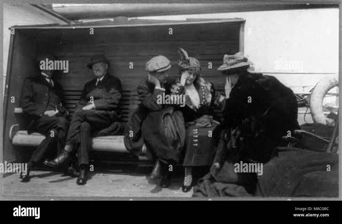 Survivors of the Titanic disaster aboard the Carpathia, including Mr. and Mrs. G.A. Harder and Mrs. Charles M. Hayes. The image captures the poignant moment of conversation between the survivors. Stock Photo