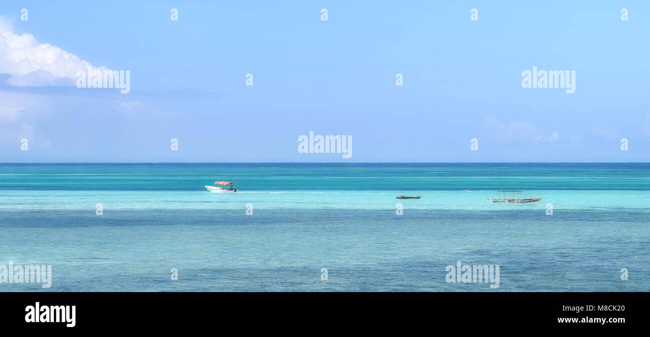 Turquoise sea and fishing boats. Stock Photo