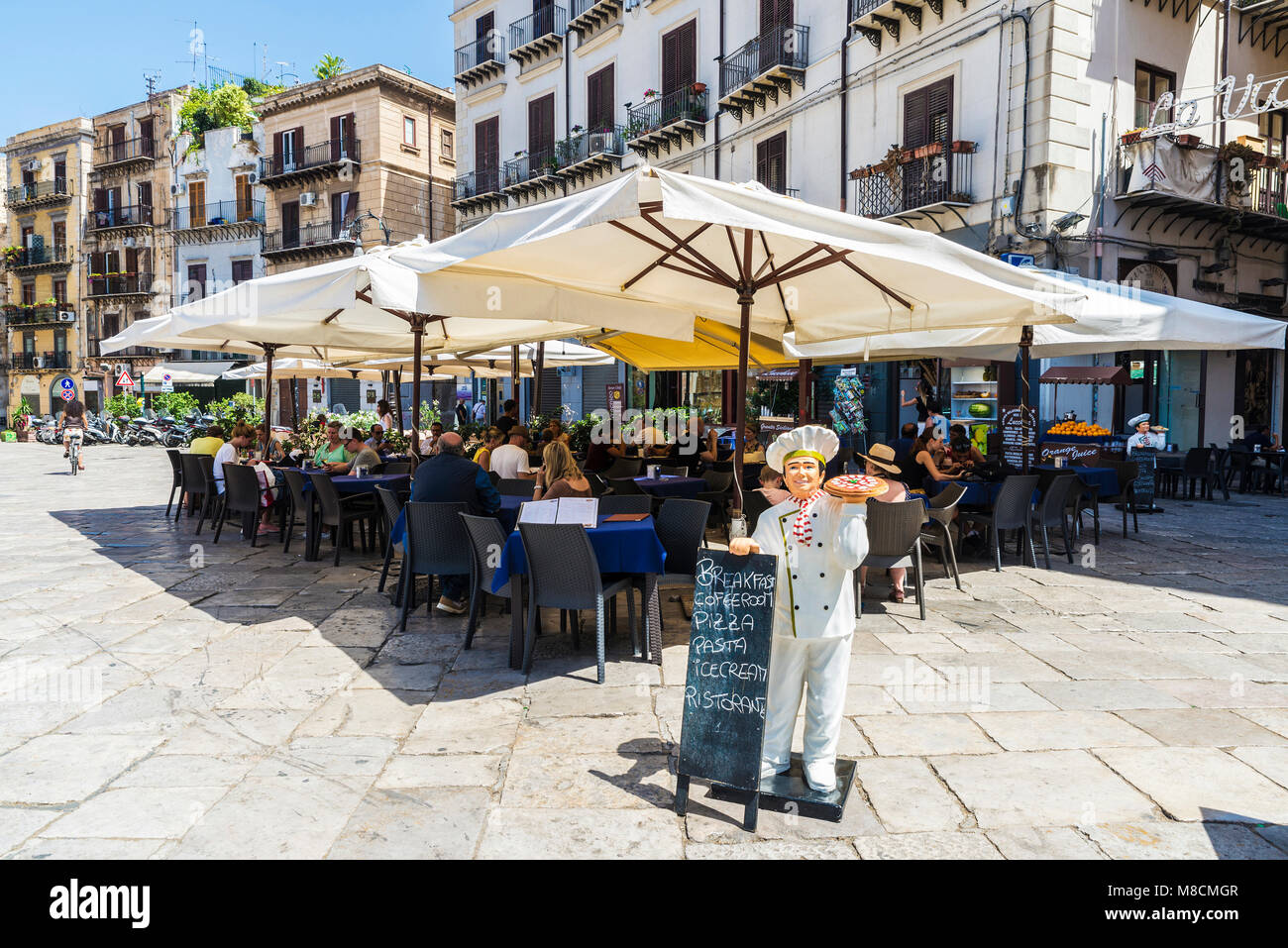 Palermo, Italy - August 10, 2017: Terrace of a restaurant bar with people around in the old town of Palermo in Sicily, Italy Stock Photo