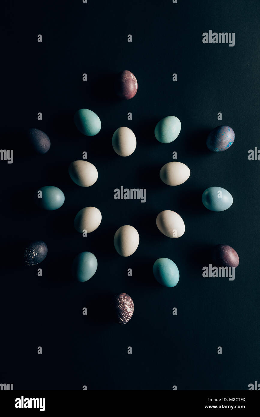 flat lay of colored painted easter eggs on dark surface Stock Photo - Alamy