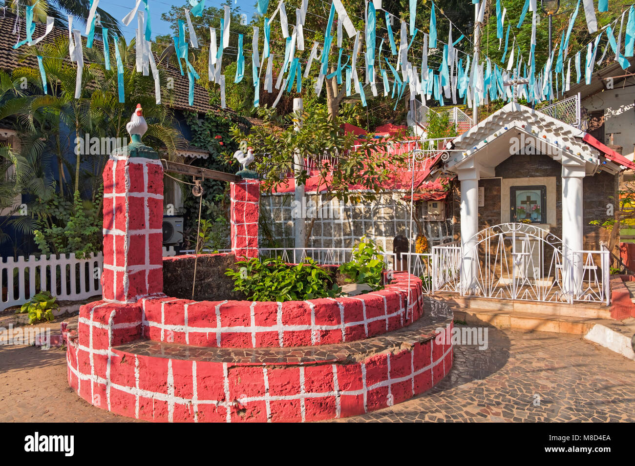 Old well and shrine Fontainhas quarter Panjim Tiswadi Goa India Stock Photo