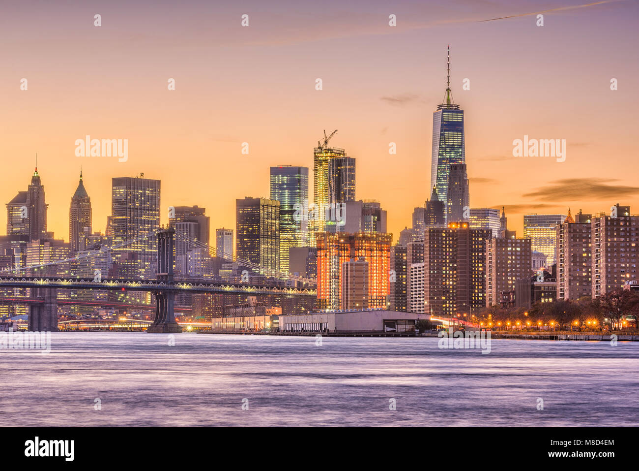 New York City, USA skyline on the East River with Brooklyn Bridge at dusk. Stock Photo