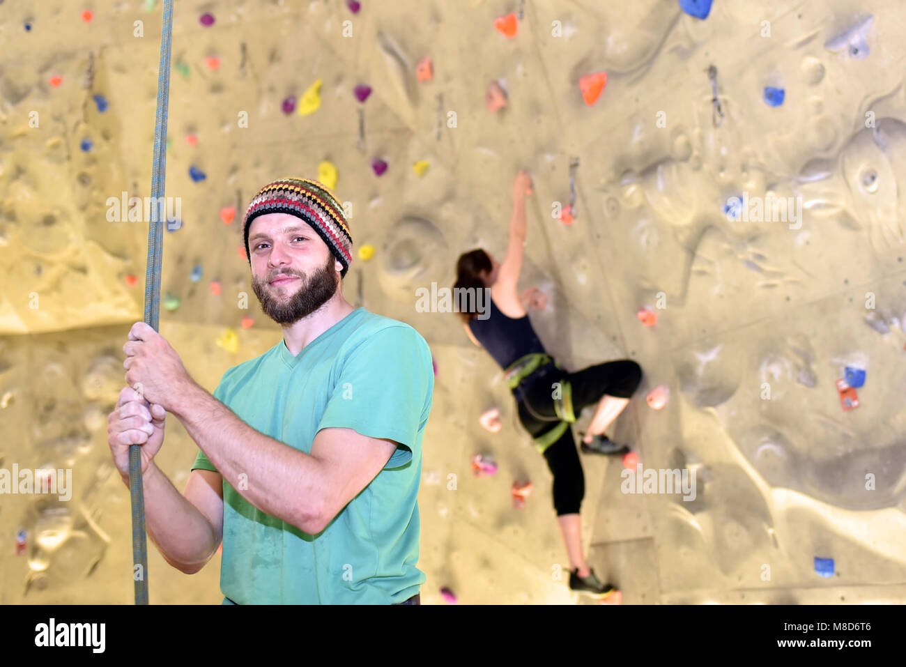 people bouldering in a climbing hall - indoor sports Stock Photo
