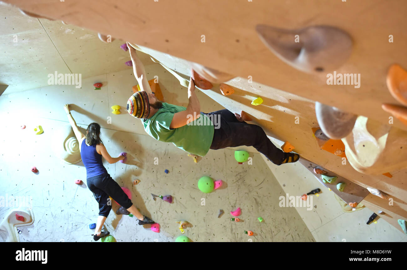 young sporty couple of climbers in a climbing hall Stock Photo