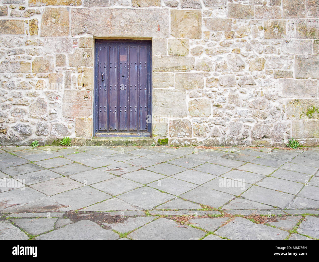 Door in the medieval stone wall Stock Photo