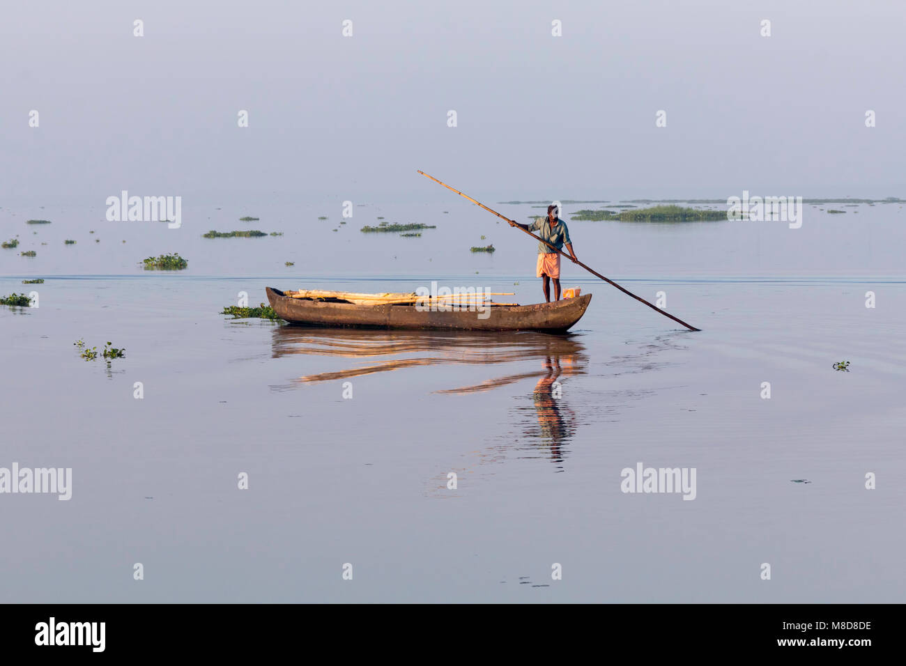 Fisherman at work, early morning just after dawn at Vembanad Lake, Kumarakom, Kerala, India Stock Photo