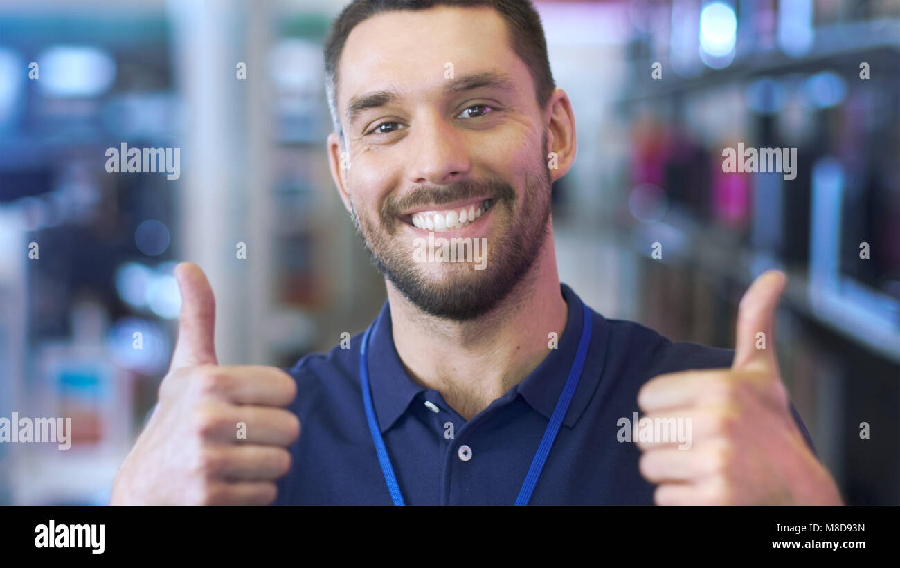 Portrait of a Professional Consultant Smiling and Giving Thumbs Up in the Bright, Modern Electronics Store.The Depth of Field Shot. Stock Photo