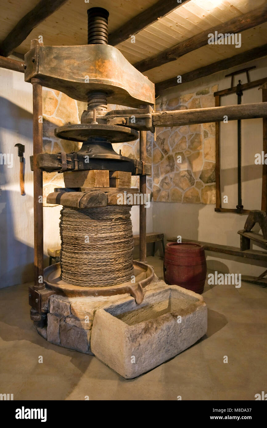 Ancient olive oil production machinery, mechanical manual press and stone oil container on Island Korcula in Croatia Stock Photo