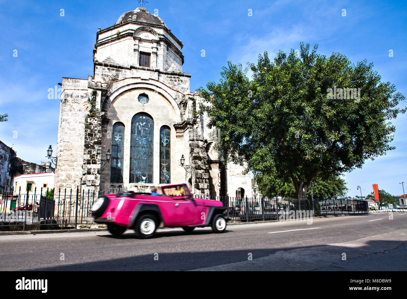 Havana, Cuba - December 12, 2016:  Pink American Classic Car in front of  the Church Iglesia de San Francisco de Paula Stock Photo
