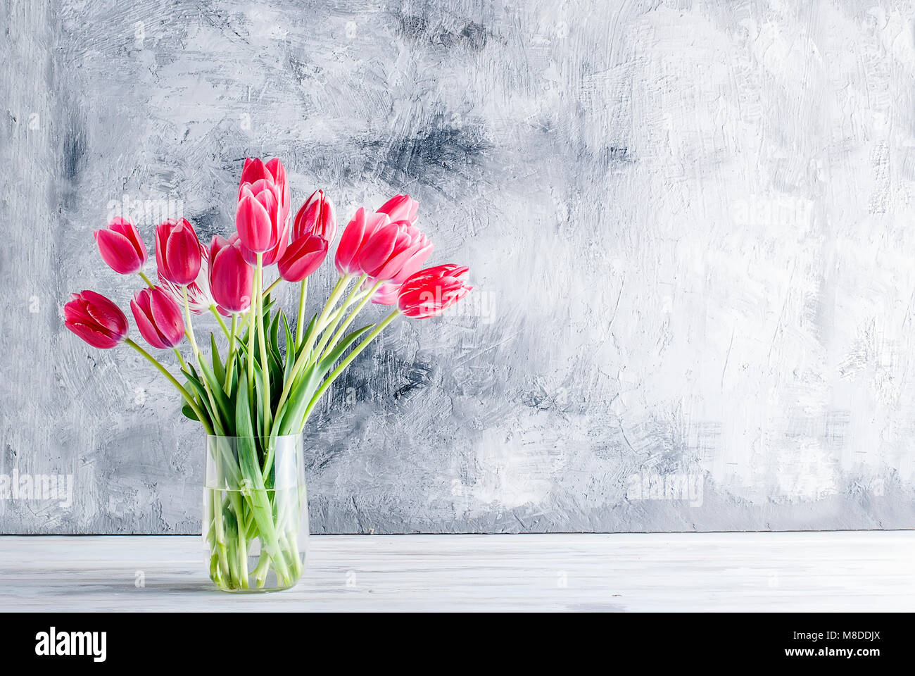 A bouquet of pink tulips on a white table, Copy space.Holiday concept ...