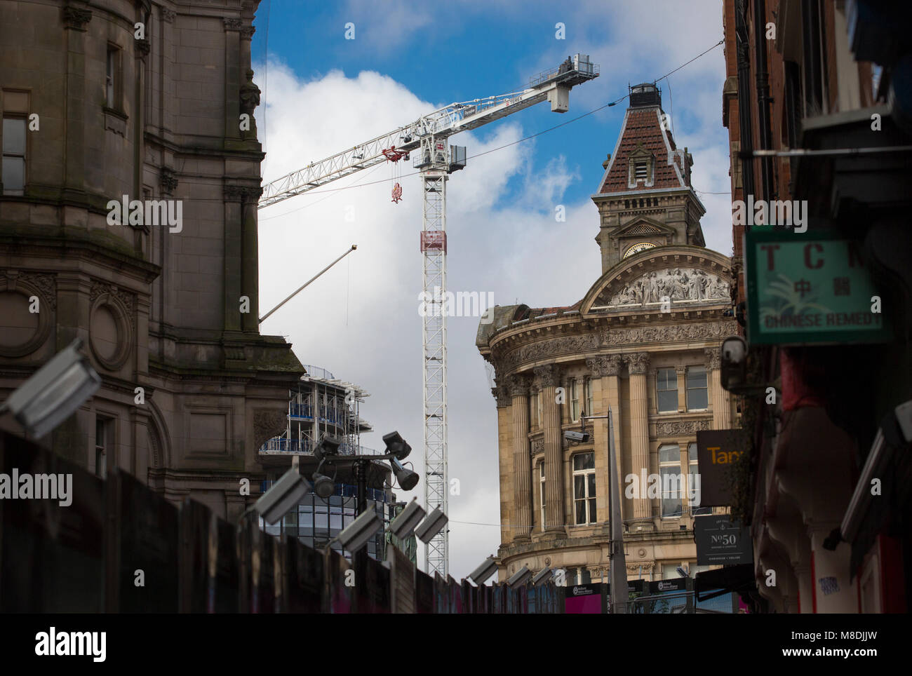 Old classical buildings in Birmingham City Centre frame a modern