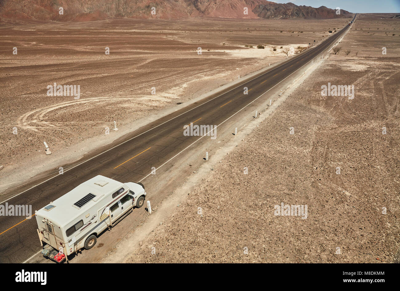 High angle view of campervan parked on desert roadside, Hacienda Ventilla, Ica, Peru Stock Photo