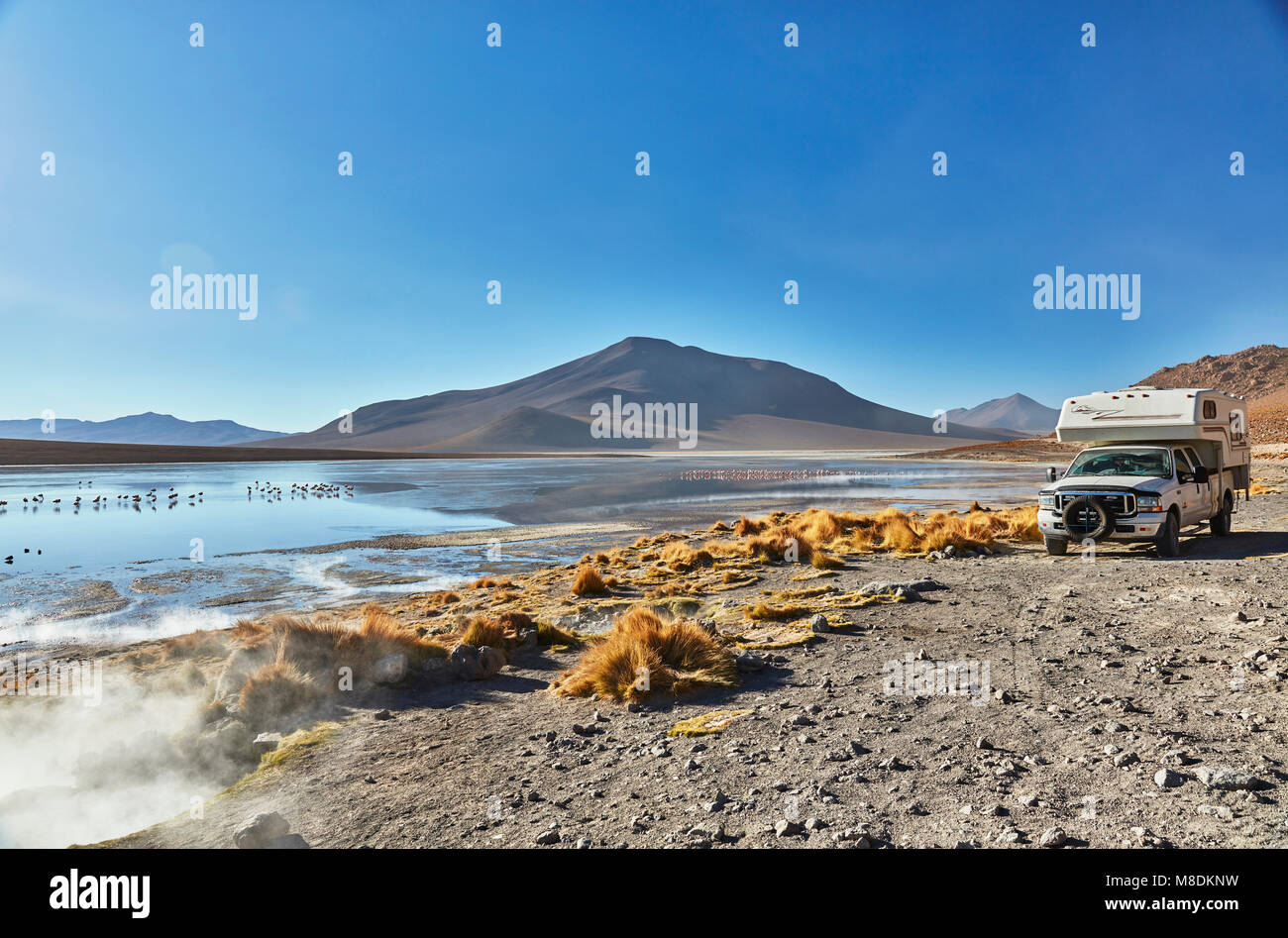 Recreational vehicle moving across landscape, Chalviri, Oruro, Bolivia, South America Stock Photo