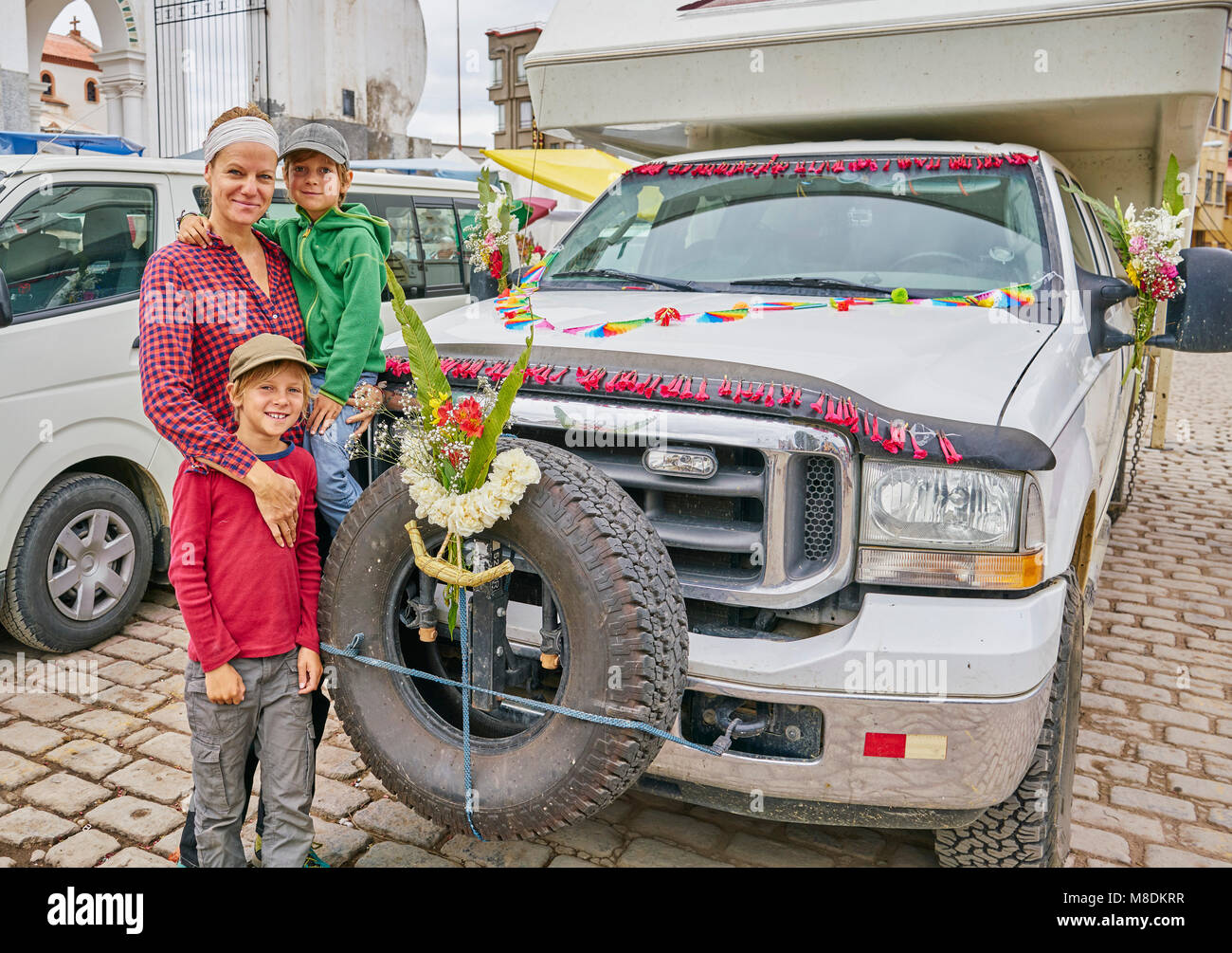 Portrait of mother and sons beside recreational vehicle, Copacabana, Oruro, Bolivia, South America Stock Photo