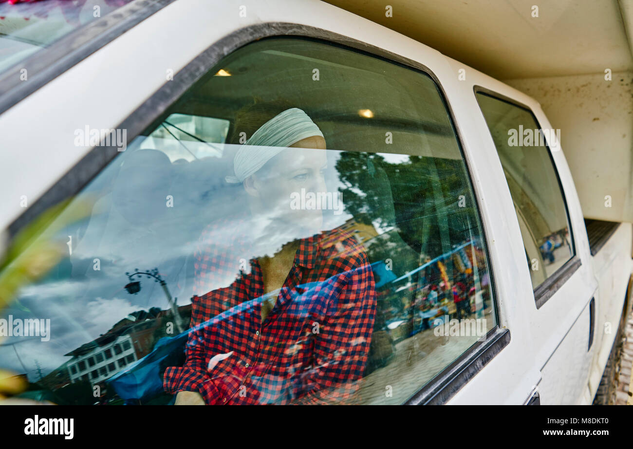 Woman inside recreational vehicle, looking out of window, Copacabana, Oruro, Bolivia, South America Stock Photo