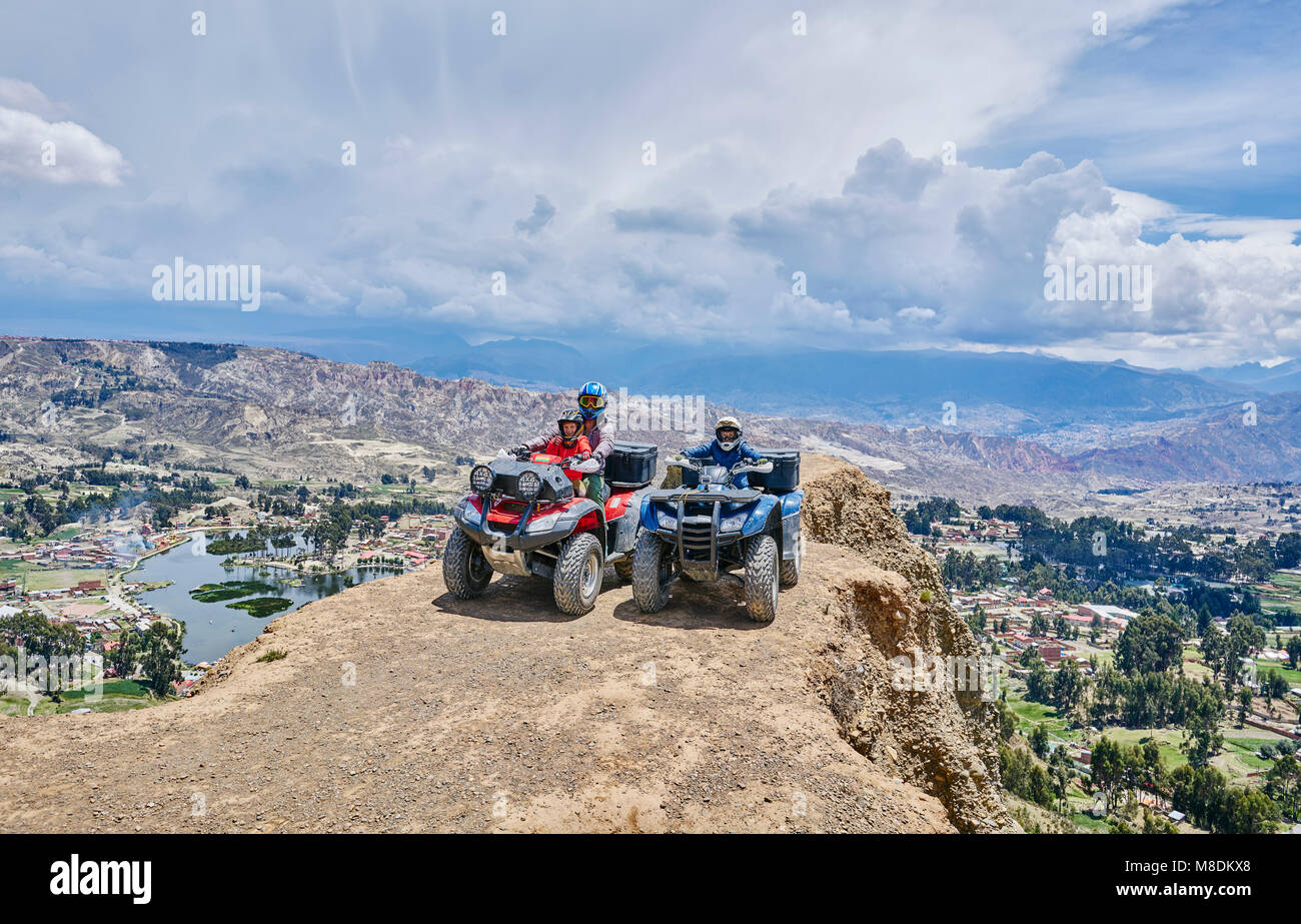 Mother and sons on top of mountain, using quad bikes, La Paz, Bolivia, South America Stock Photo