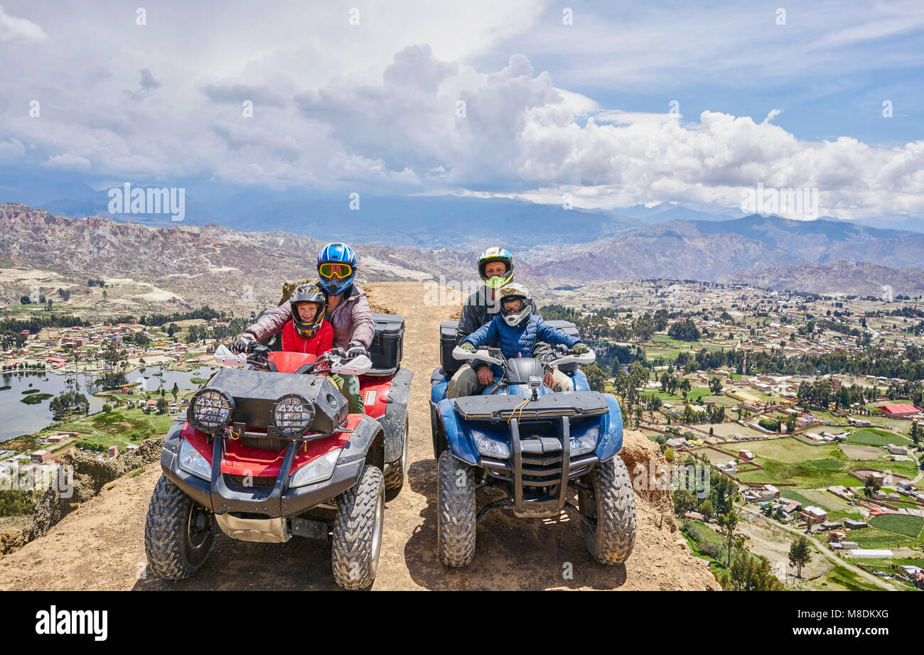 Family on top of mountain, using quad bikes, La Paz, Bolivia, South America Stock Photo