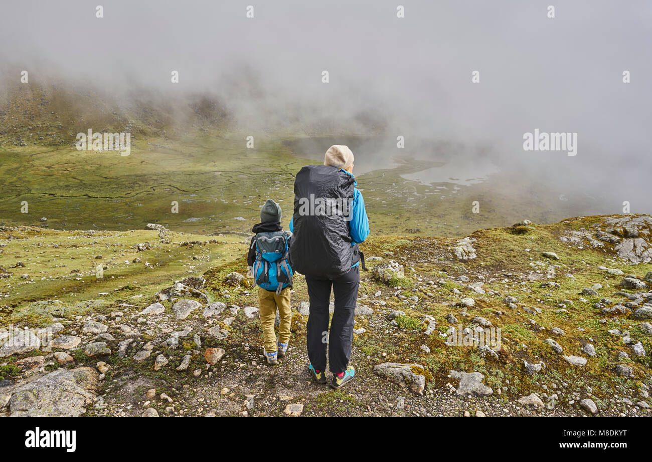 Mother and son, trekking through landscape, rear view, Ventilla, La Paz, Bolivia, South America Stock Photo