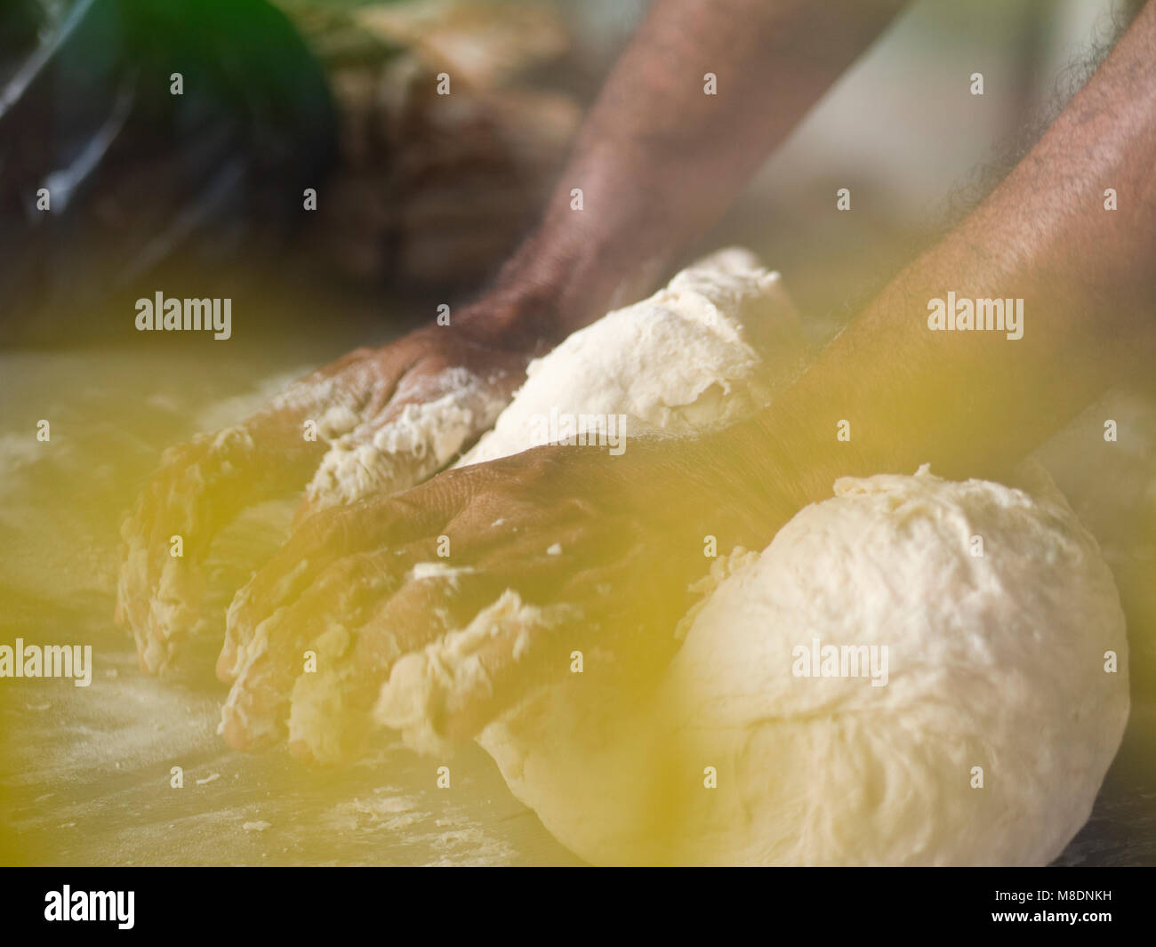 Man kneading roti dough Stock Photo