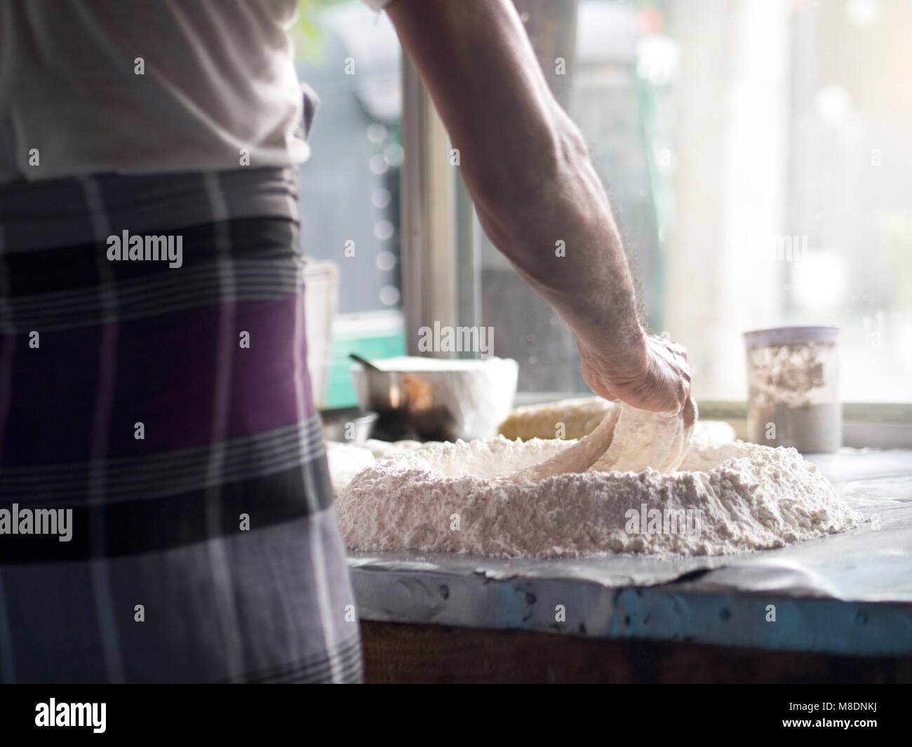 Man preparing roti dough Stock Photo
