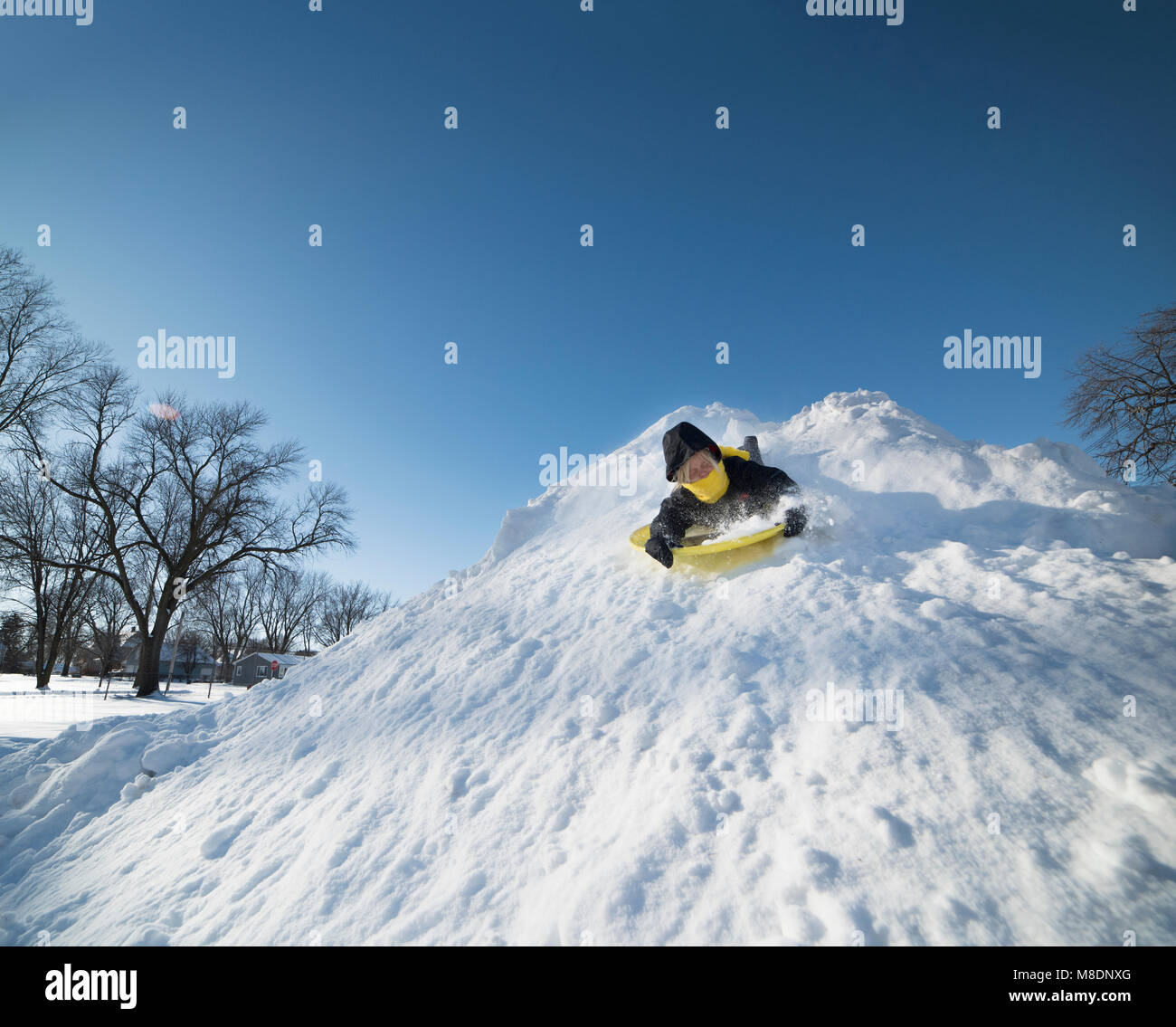 Boy sledding on snow Stock Photo