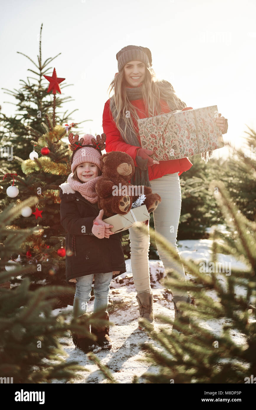 Girl and mother in christmas tree forest with christmas presents, portrait Stock Photo