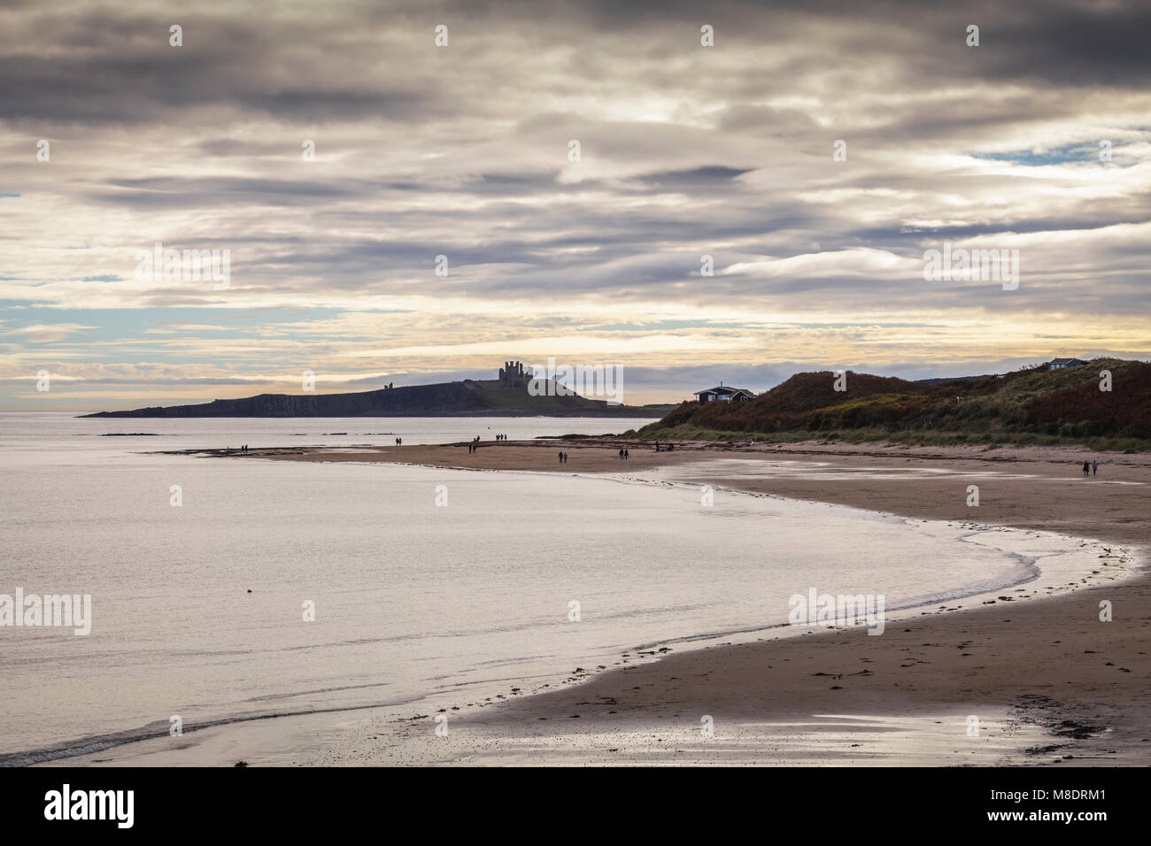 Dunstanburgh Castle and Low NewtonbytheSea in Northumberland Stock Photo Alamy