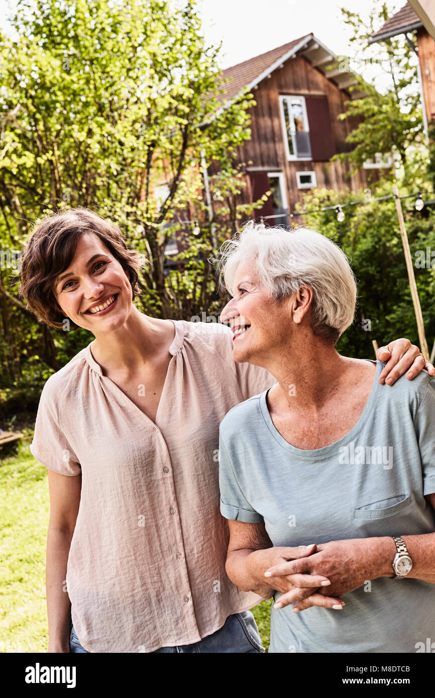 Portrait of senior woman with grown daughter, outdoors, smiling Stock Photo