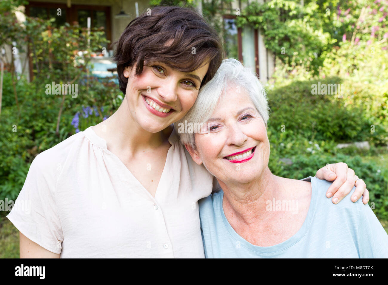 Portrait of senior woman with grown daughter, outdoors, smiling Stock Photo