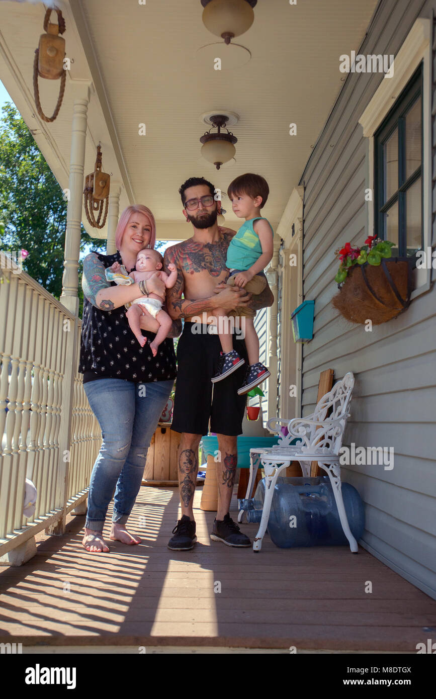 Family in front porch of house Stock Photo