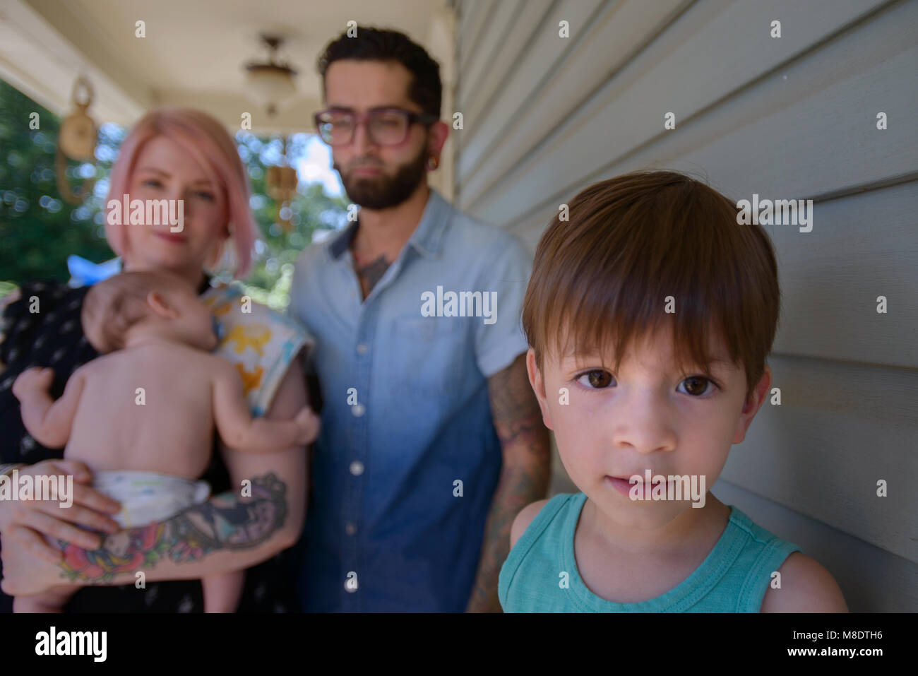 Family in front porch of house Stock Photo