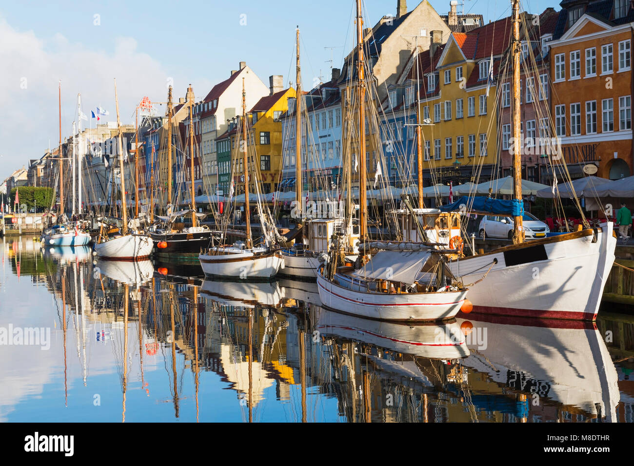 Moored boats and colourful 17th century town houses on Nyhavn canal, Copenhagen, Denmark Stock Photo